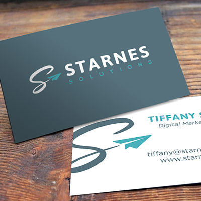 business cards featuring Starnes Solutions new brand resting on a wooden table